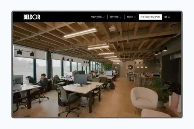 Commercial workspace with timber ceiling beams, open-plan desks, and BELCOR navigation